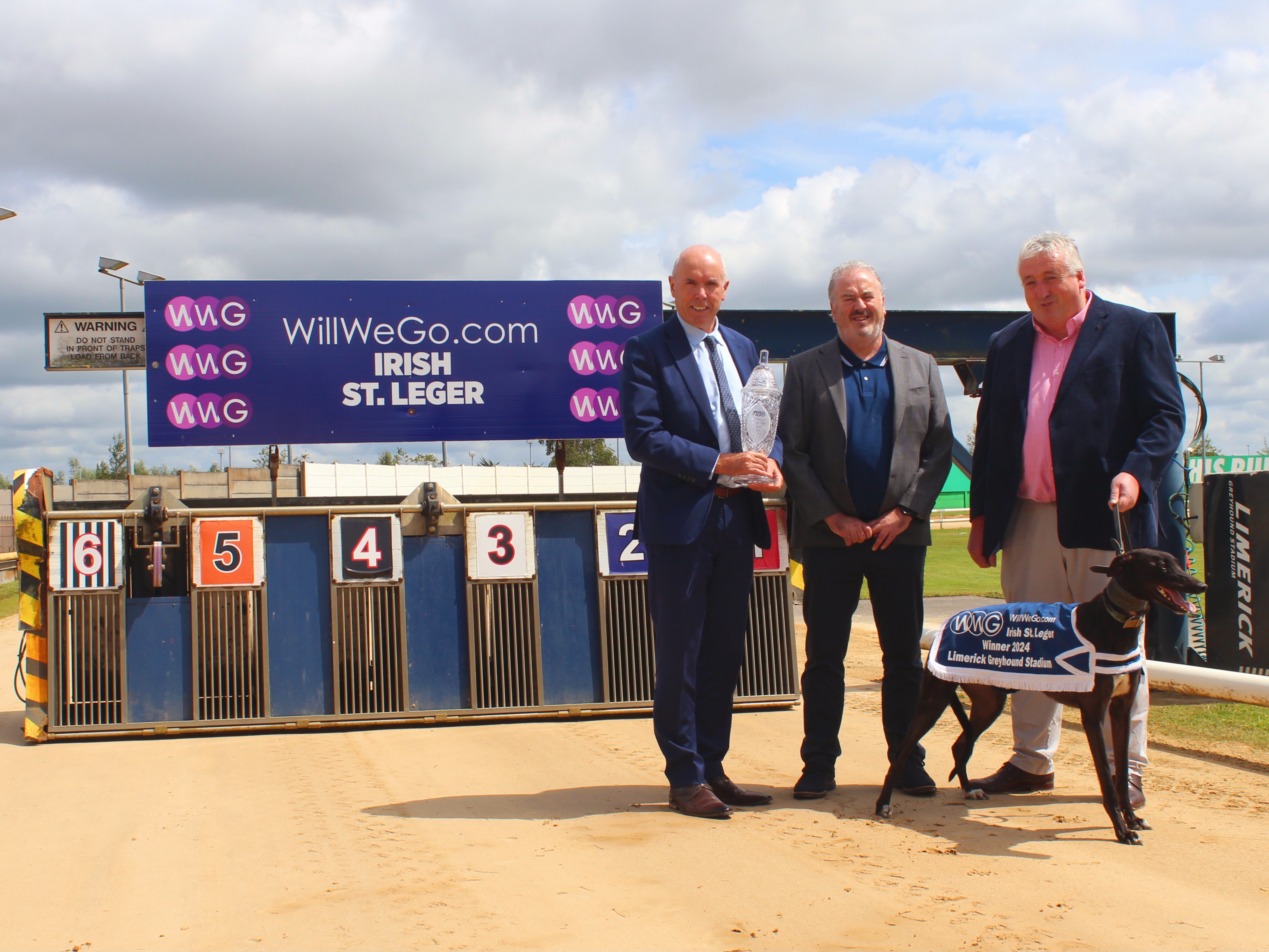 Tim Lucey CEO of GRI, holding the trophy for this year’s WillWeGo.com Irish St. Leger at Limerick Greyhound Stadium withRay Quinn, representing the sponsor, and Jody Thompson, Racing Manager, with Sombra the greyhound. Tim Lucey CEO of GRI, holding the trophy for this year’s WillWeGo.com Irish St. Leger at Limerick Greyhound Stadium withRay Quinn, representing the sponsor, and Jody Thompson, Racing Manager, with Sombra the greyhound.