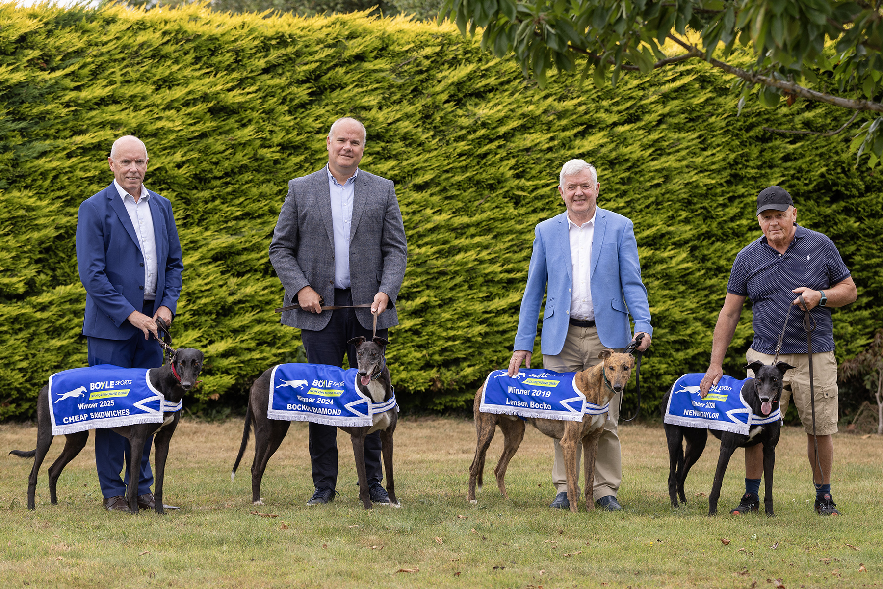 Pictured at the launch of the 2026 BOYLE Sports Irish Greyhound Derby at Riverside Kennels in Tipperary are L-R: Tim Lucey (CEO, GRI), Kieran Holden (Sponsorship Manager BOYLE Sports), Pat Flanagan (Chairman GRI) and Graham Holland (5 time Irish Greyhound Derby Winning Trainer), with 4 of his 5 Irish Greyhound Derby Champions -  Lenson Bocko (2019), Newinn Taylor (2020), Bockos Diamond (2024) and Cheap Sandwiches (2025).